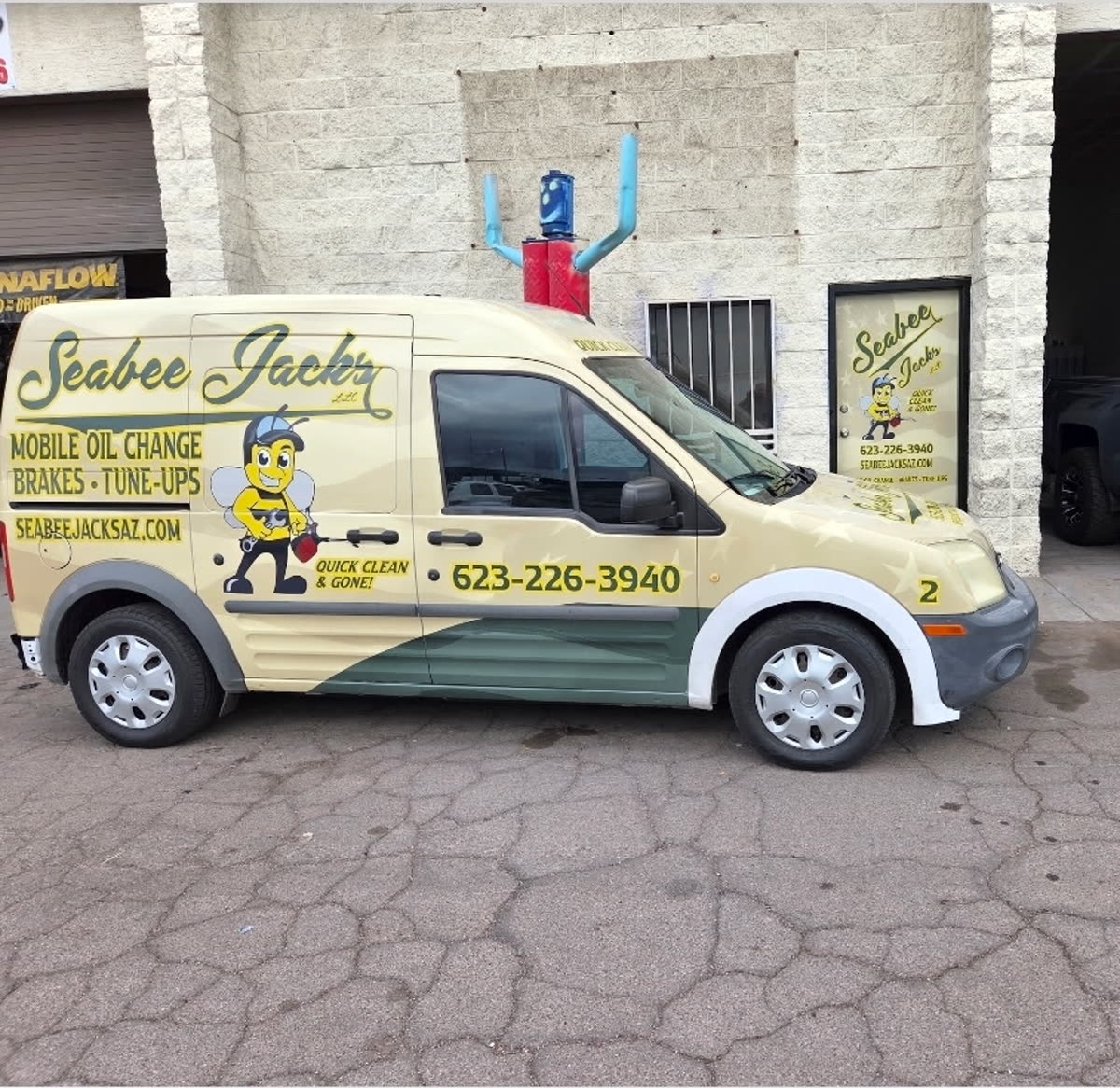 SeaBee Jack's wrapped service van parked in front of the shop at 2718 W McDowell Rd, Phoenix